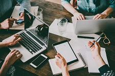 Several people collaborating together on a work project.